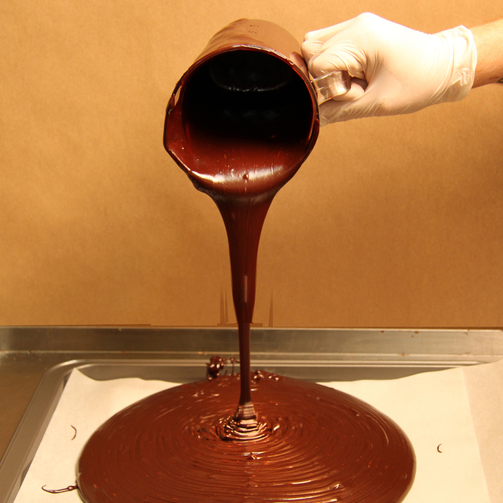 Pouring melted chocolate on a tray