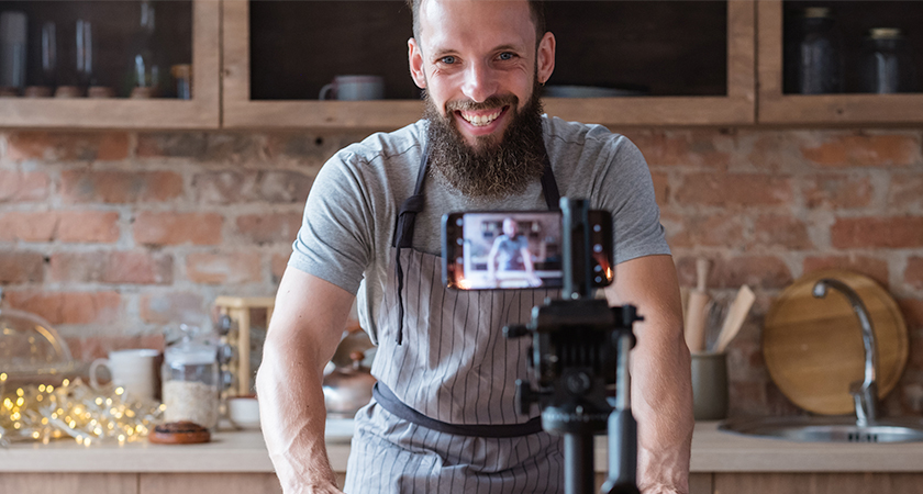 Smiling person in front of a camera